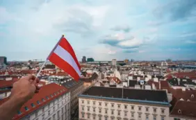 depositphotos_313180250-stock-photo-man-holds-austria-flag-in.jpg